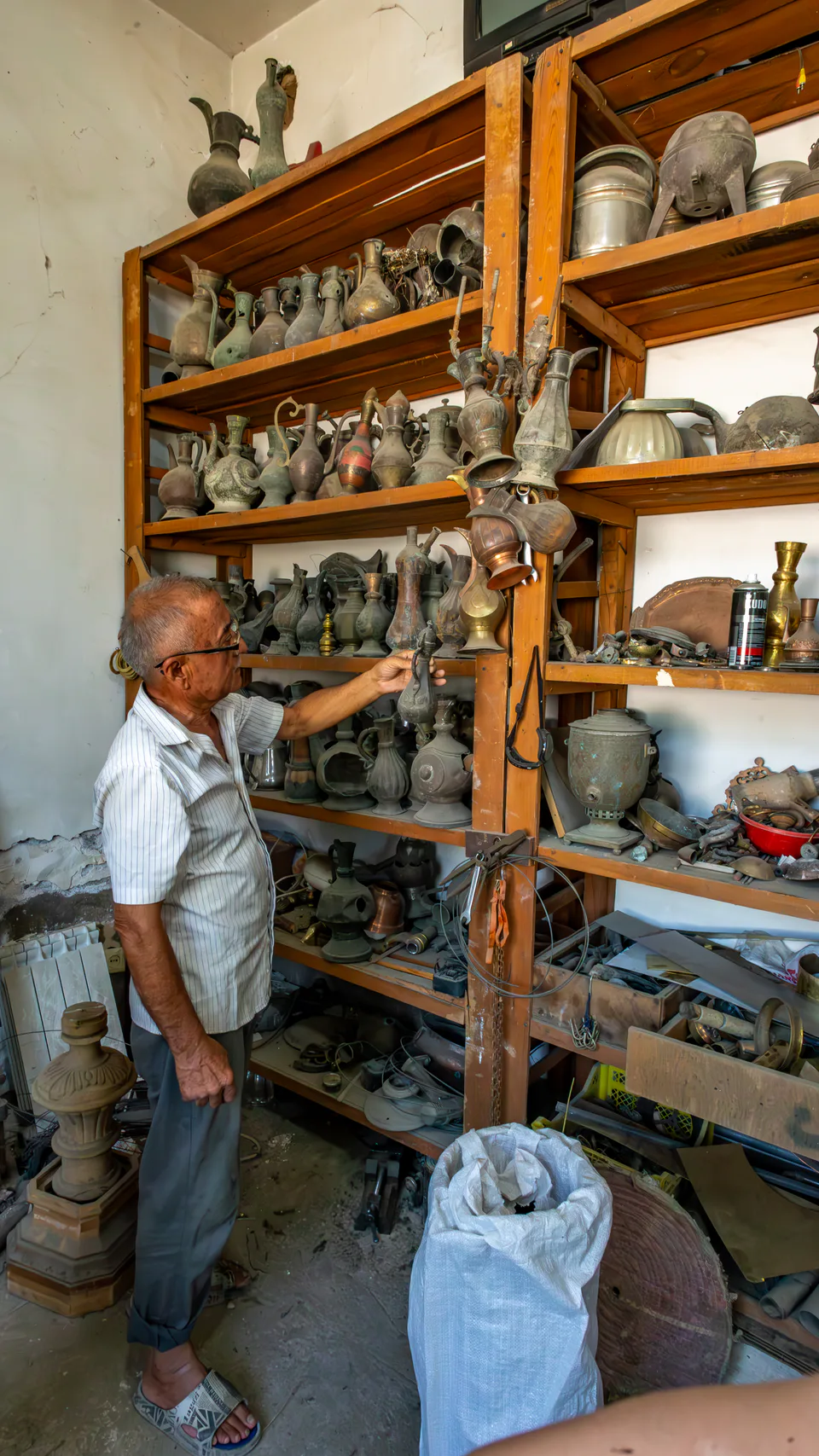 Masud Madaliyev is demonstrating his copper tableware in his workshop. Tashkent, Uzbekistan.