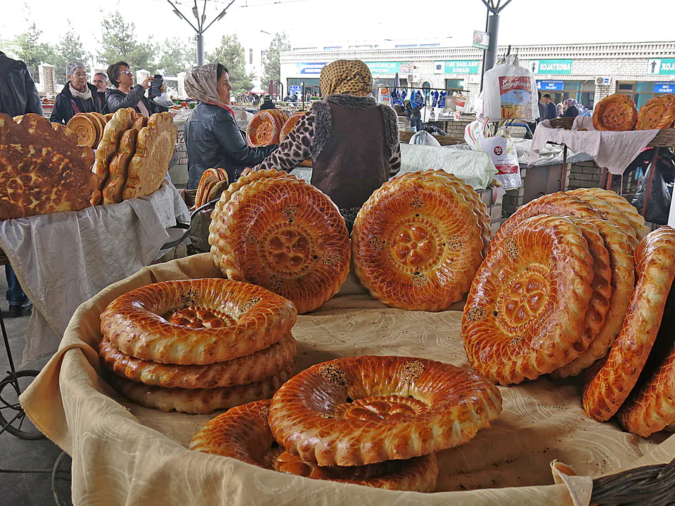 Picture showing baked bread for sale in Margilan market, Uzbekistan