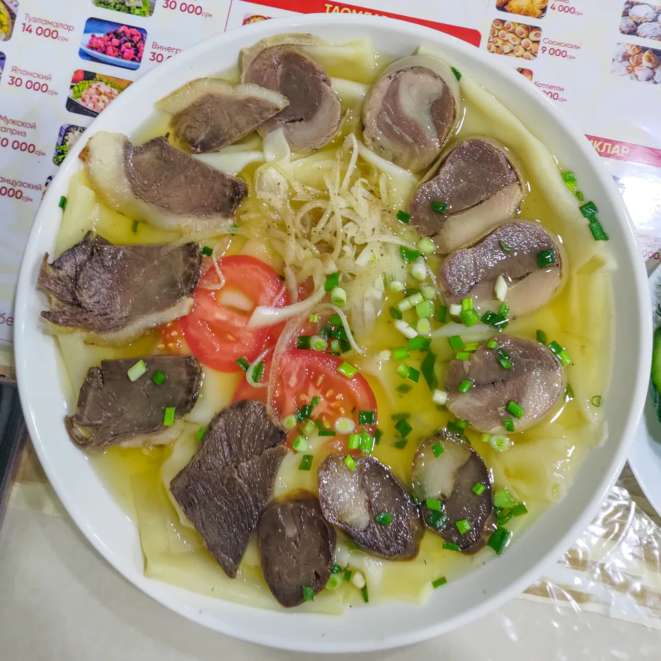 Beshbarmak with qazi on a plate at Khadra cafe. Khadra, Tashkent, Uzbekistan.