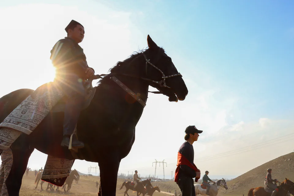 The rider who achieved victory and won the prize in Ko'pkari (or Uloq) is pictured here with the carpet awarded as his reward.