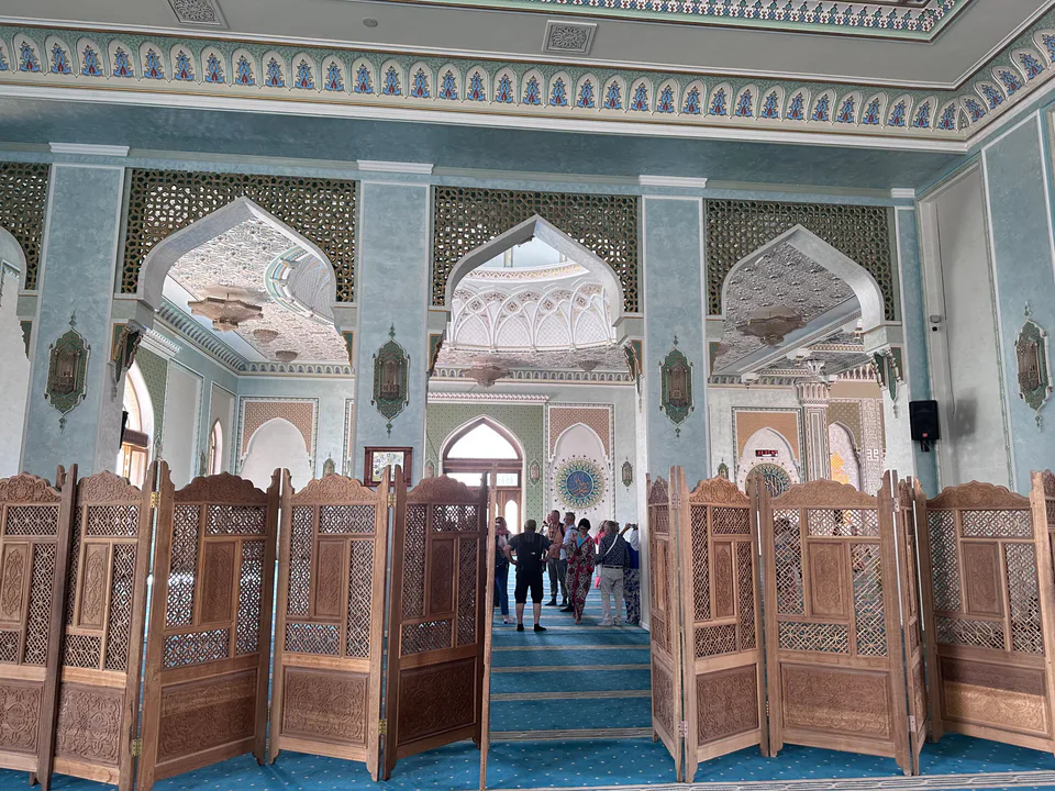 Inside the Hazrati Imam Mosque in Tashkent, a stunning example of Islamic architecture with intricate designs and ornate decorations.