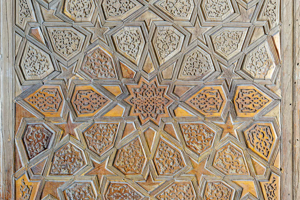 Part of a carved wooden entrance door of Kukeldash madrasa. Bukhara, Uzbekistan.