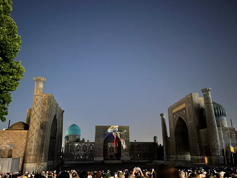 A captivating scene from the light show at Registan Square, showcasing vibrant lights illuminating the historical architecture of the square.