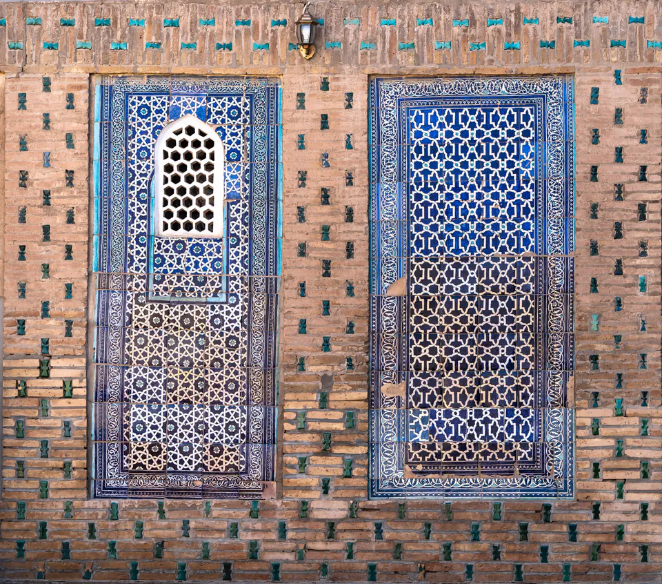 Two majolica tiled panels with one painfully misplaced window on a wall of Tash Khaouli palace. Khiva, Xorazm Region, Uzbekistan.