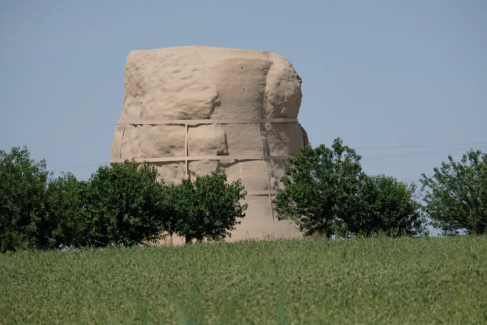 Distant view of the Zurmala Stupa (Buddhist monument from the Kushan era) amidst the surrounding fields near Termez, Surxondaryo Region, Uzbekistan.