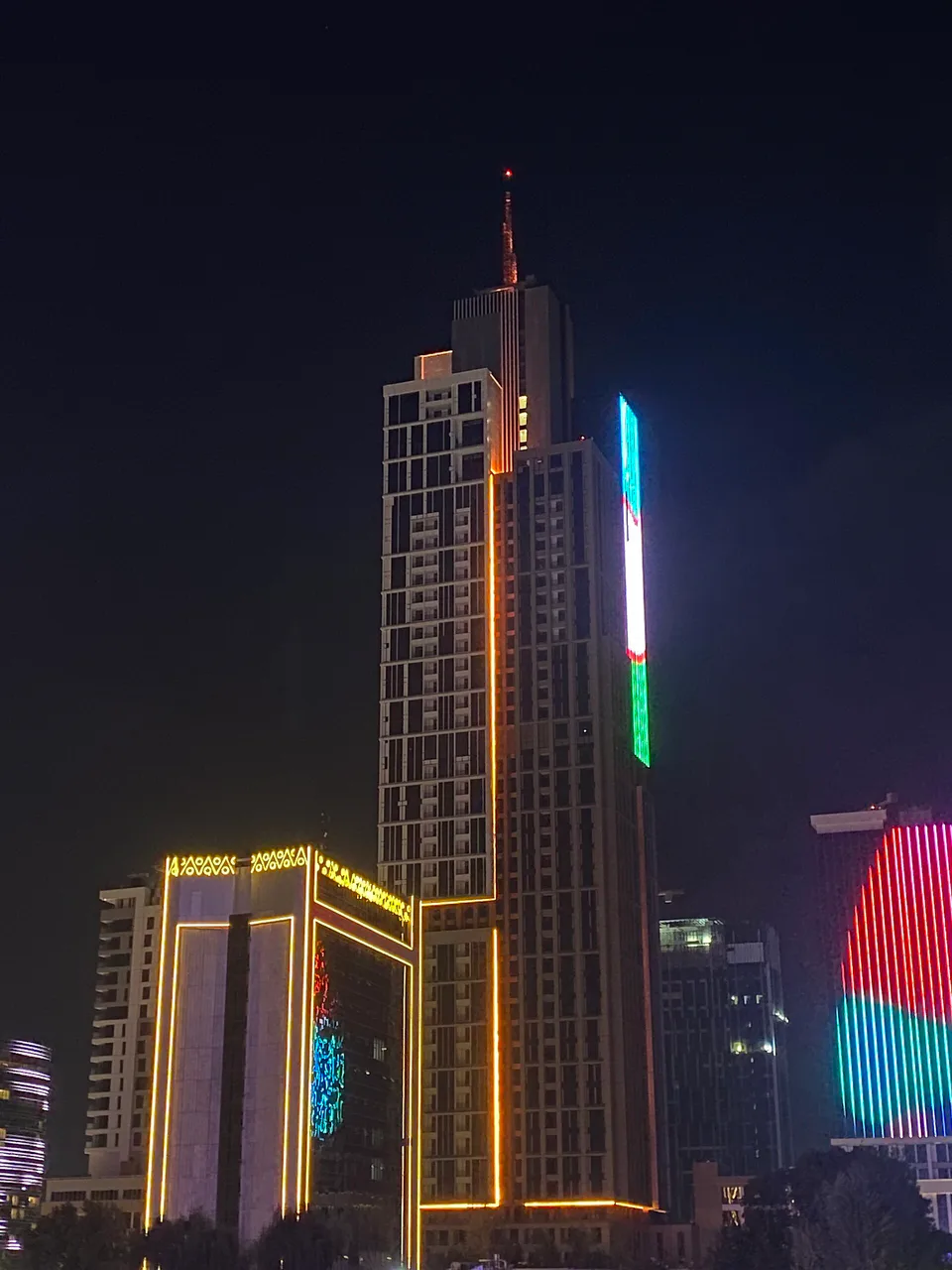 Night lights in Tashkent: illuminated skyscrapers showcasing urban vibrancy.